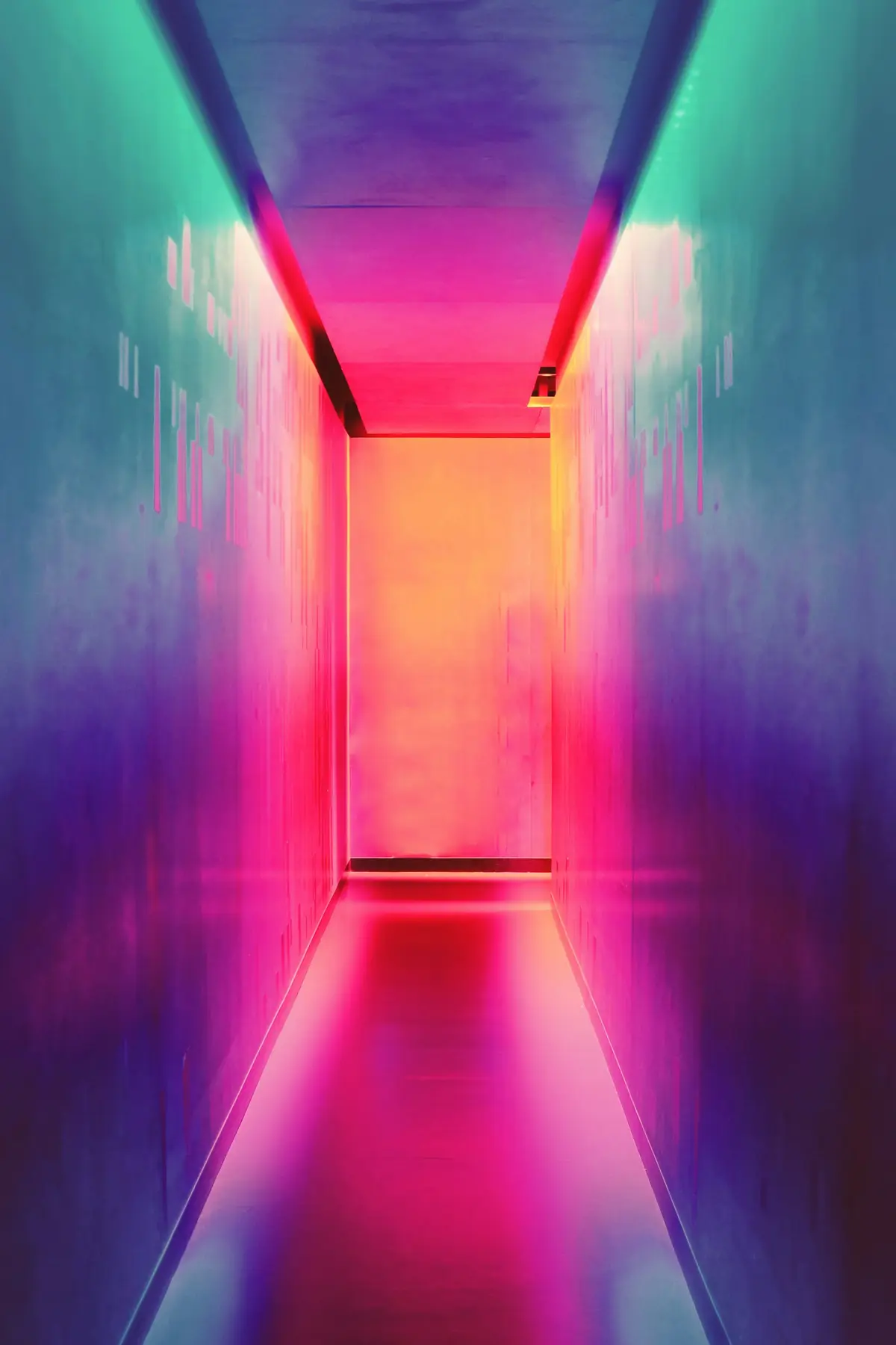 A vivid pink, orange, blue, and purple architectural passage