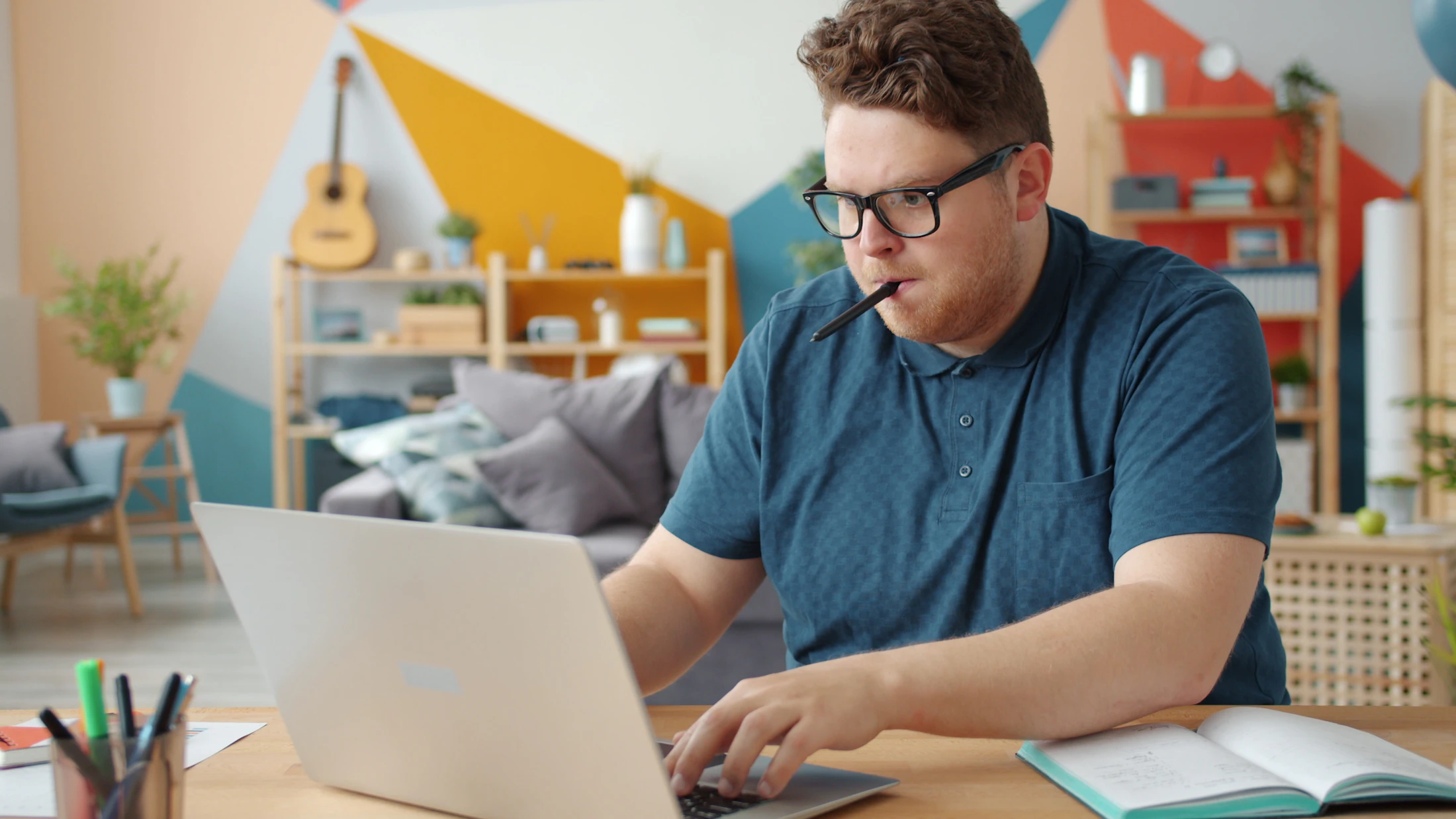 A focused small-business owner working from a colorful studio
